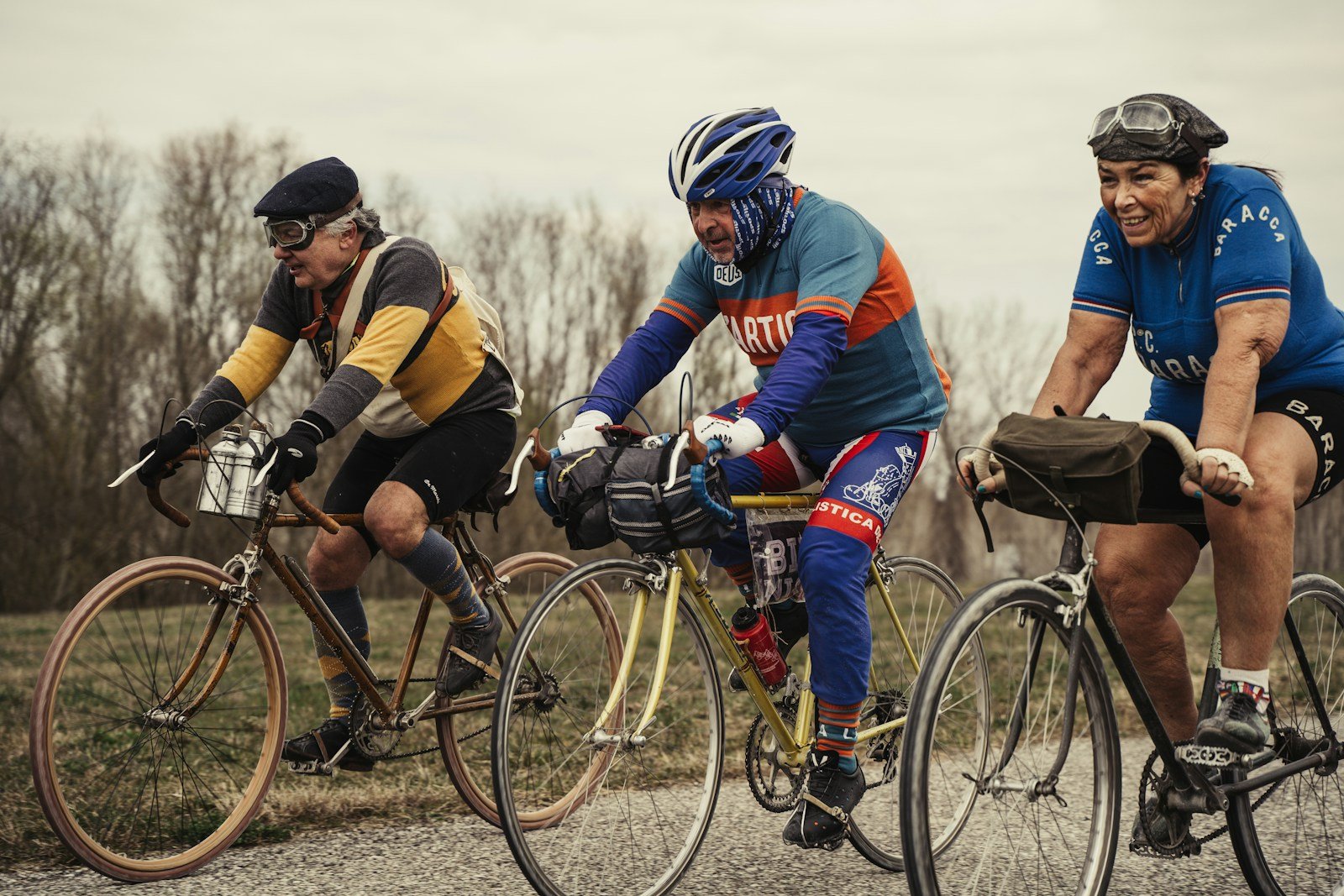 a group of men riding bikes down a road