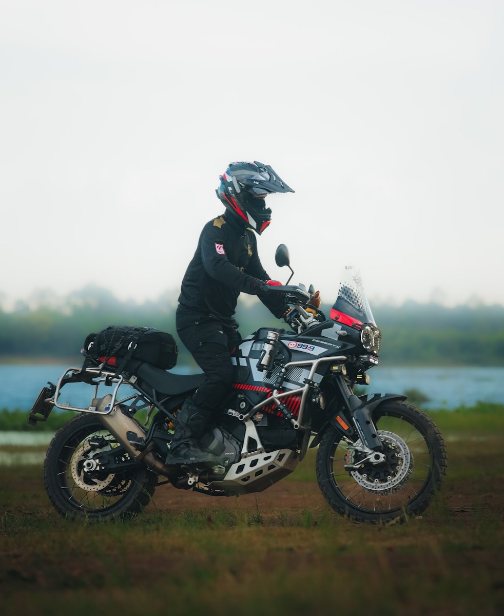 Rider on a motorcycle by a body of water
