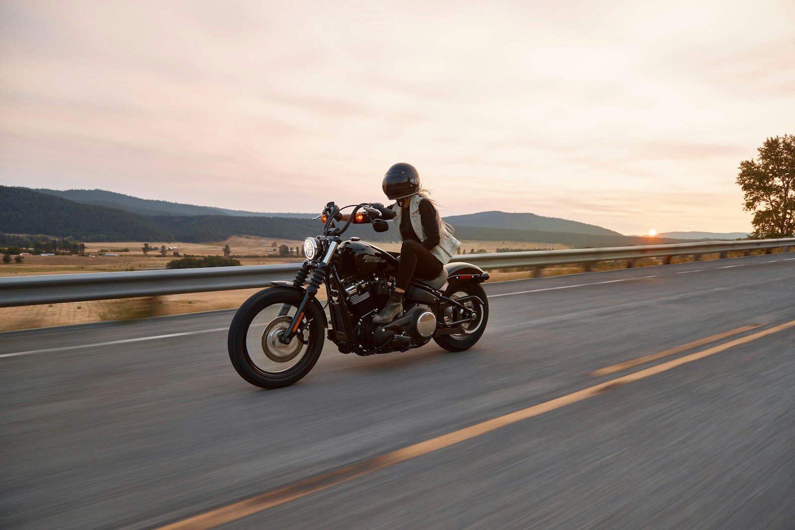 man on black cruiser motorcycle in highway