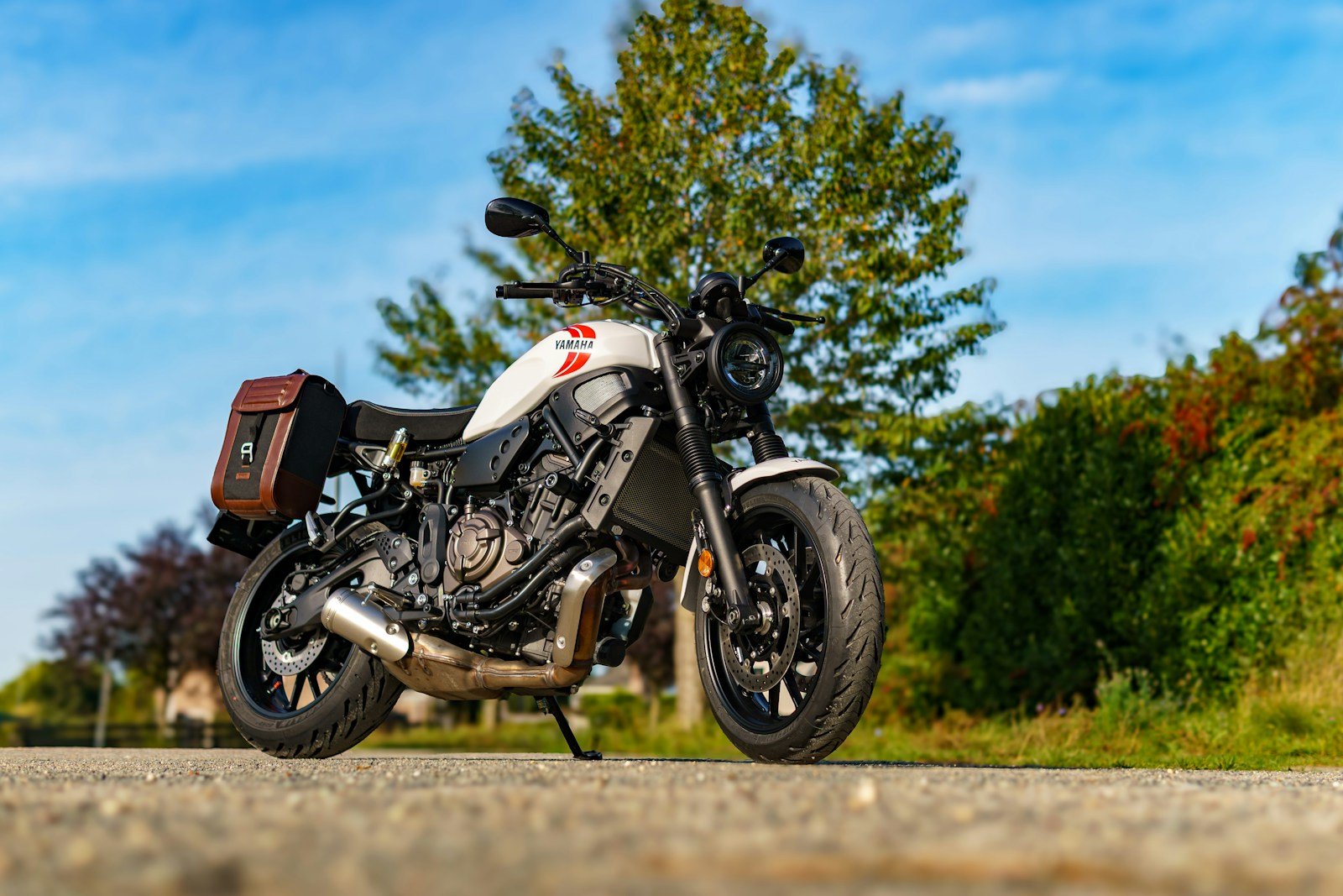 White motorcycle with saddlebags on a road
